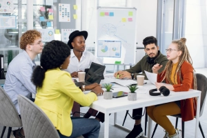 A digital marketing team sits around a table while they talk about the proper usage of ChatGPT ads for personal injury law firms